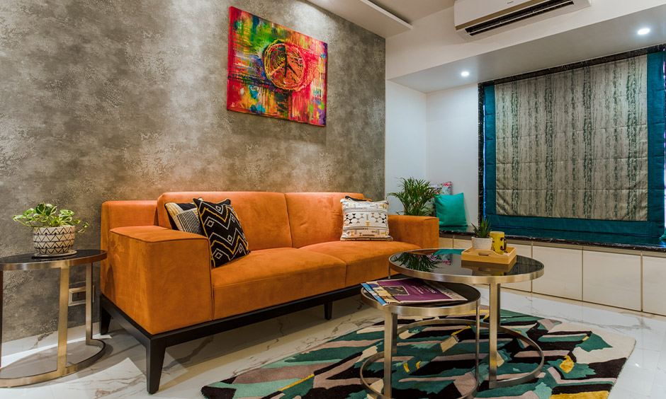 A yellow sofa in a living room designed by high end interior designers in mumbai