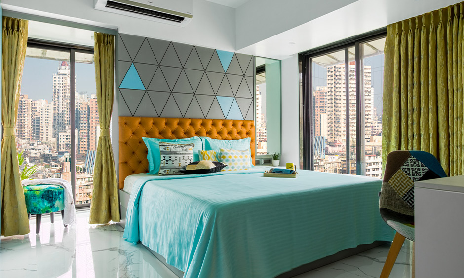 A bedroom with big windows designed by one of the best interior stylist mumbai