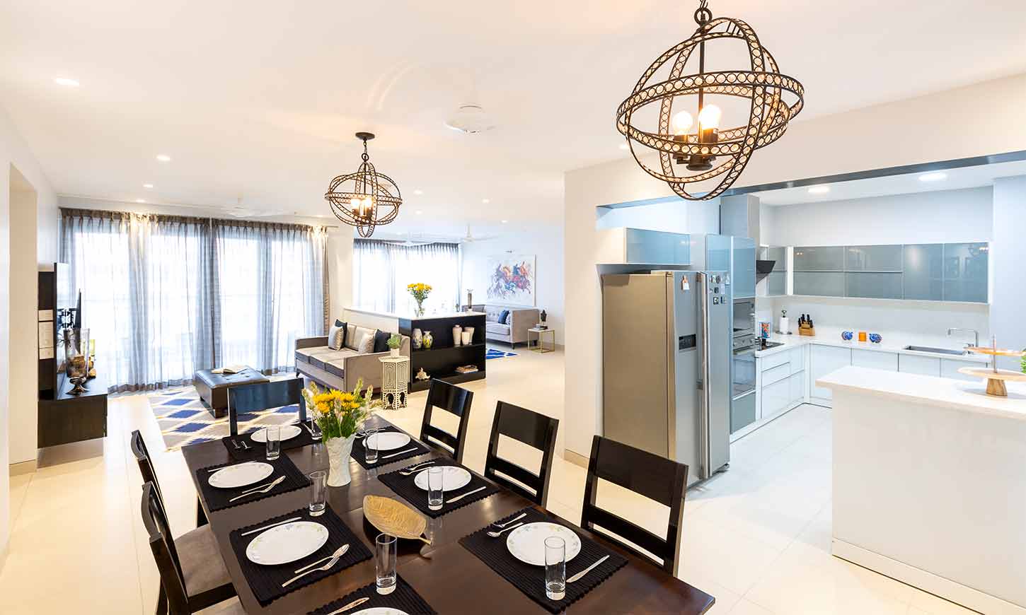 A dining area with kitchen designed by one of the best interior designing companies in bangalore
